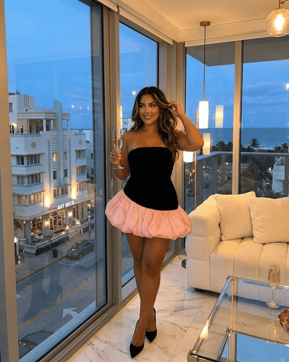 Model showcasing the Selina Mini Dress by Slimona, featuring a strapless velvet bodice and playful pink puff skirt.