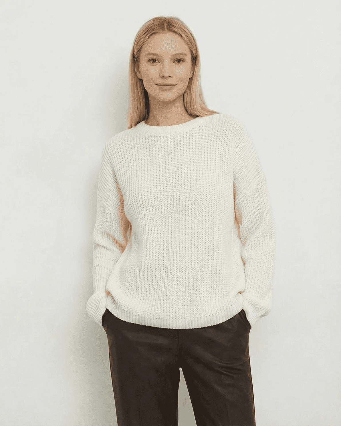 Woman wearing the Seren Sweater by Slimona, a loose fit thick ribbed knitwear in ivory.