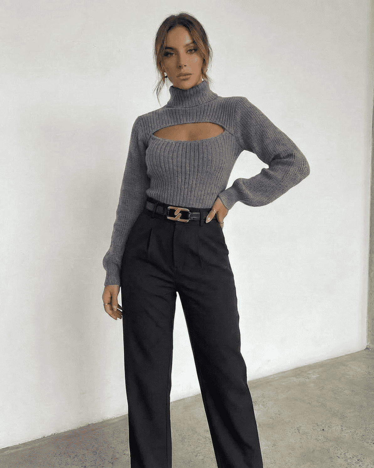 Model wearing the Slate Sweater by Slimona featuring a mock neck and cut-out design.