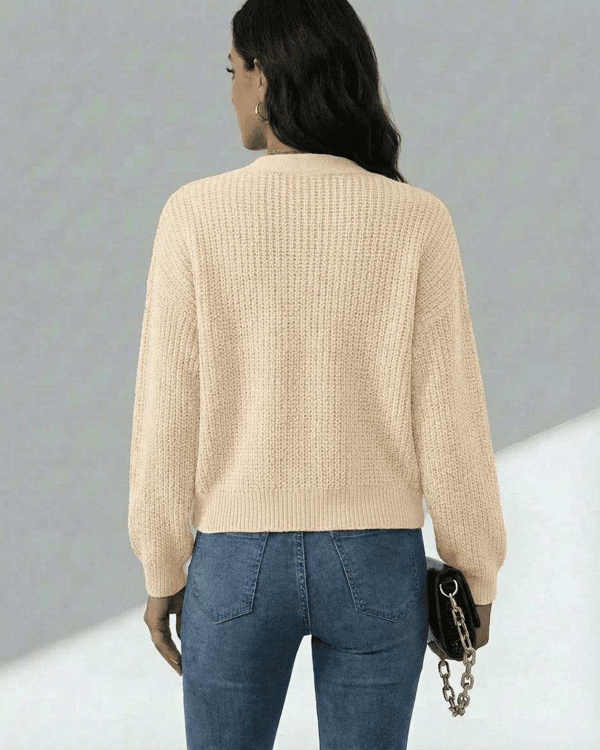 Solene Cardigan by Slimona, showing a woman from the back wearing a beige knit cardigan with long sleeves.