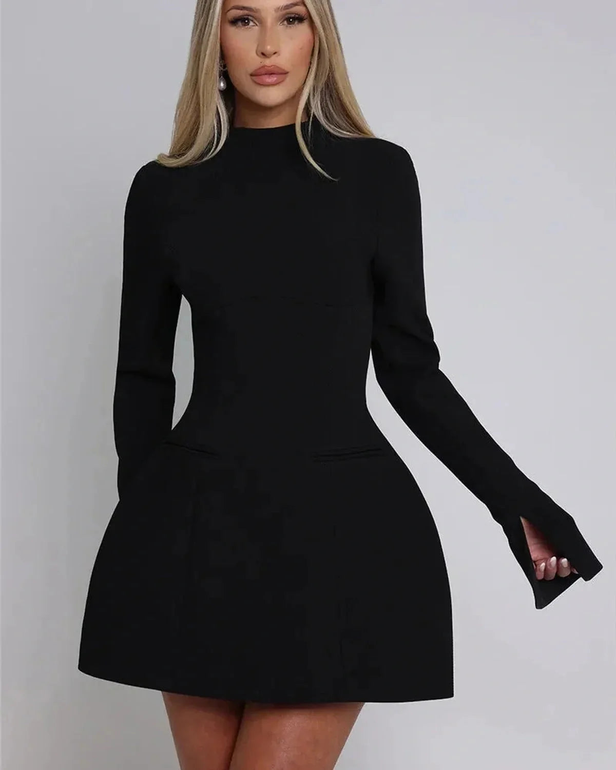 Chic black Tess Mini Dress featuring long sleeves and stylish slit cuffs, perfect for wedding guests or cocktail parties.