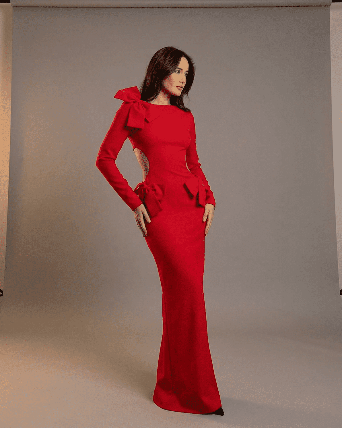 Valencia Maxi Dress by Slimona featuring cut-out waist and sculptural bows in a striking red color.