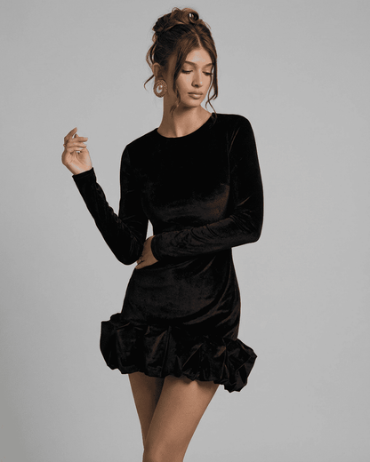Velora Mini by Slimona - Luxe black velvet bodycon dress with pleated hem and long sleeves.
