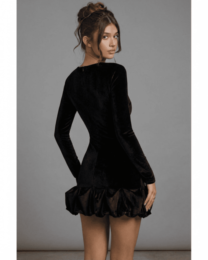 Velora Mini by Slimona – Black velvet bodycon dress with long sleeves and pleated hem, showcasing a luxe silhouette.