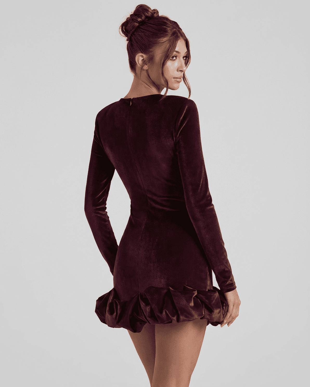 Velora Mini Dress by Slimona, showcasing a deep burgundy velvet bodycon style with a pleated hem.