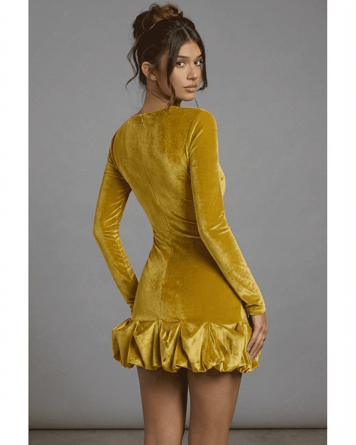 Back view of Velora Mini Yellow by Slimona, featuring a luxe velvet texture and pleated hem detail.