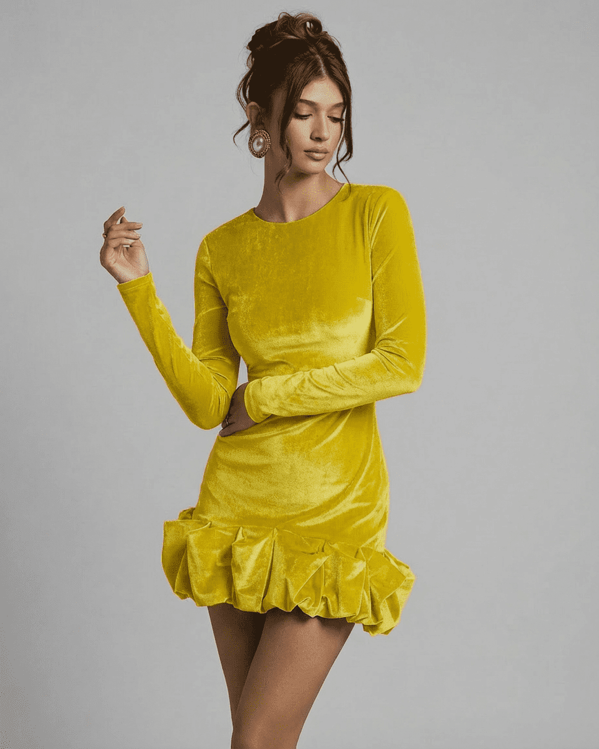 Model wearing the Velora Mini Yellow dress by Slimona, showcasing luxe velvet fabric and a pleated hem.