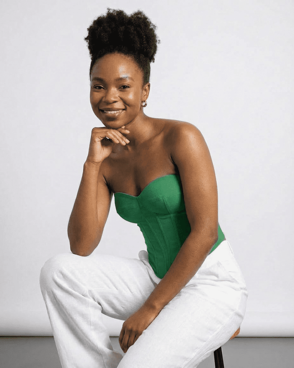 Model wearing Verde Corset Top by Slimona, showcasing its green faux denim style and structured design.