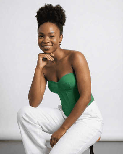 Model wearing Verde Corset Top by Slimona, showcasing its green faux denim style and structured design.