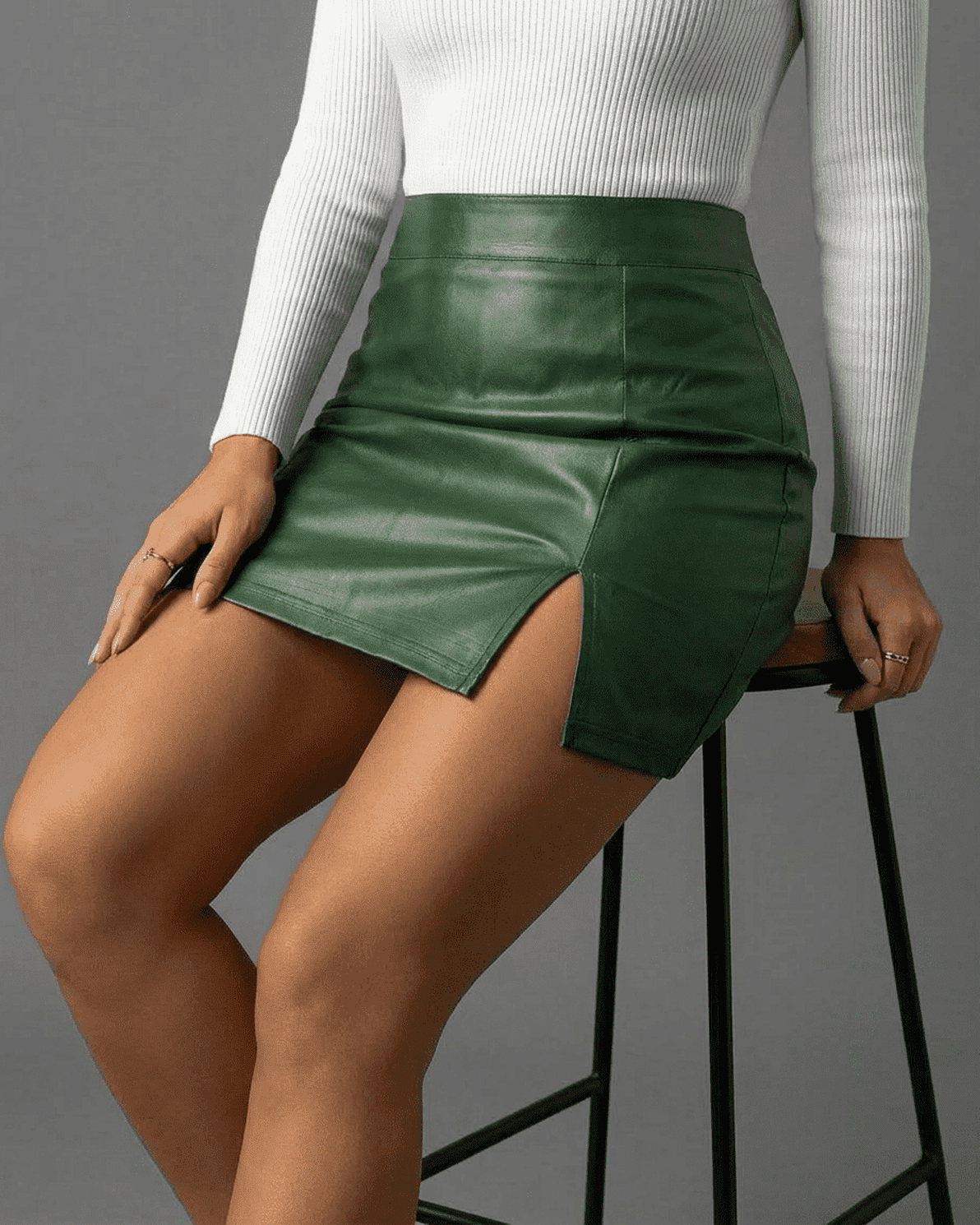 Verona Mini Skirt by Slimona in rich green, high-waisted PU A-line with side slit, perfect for modern elegance.