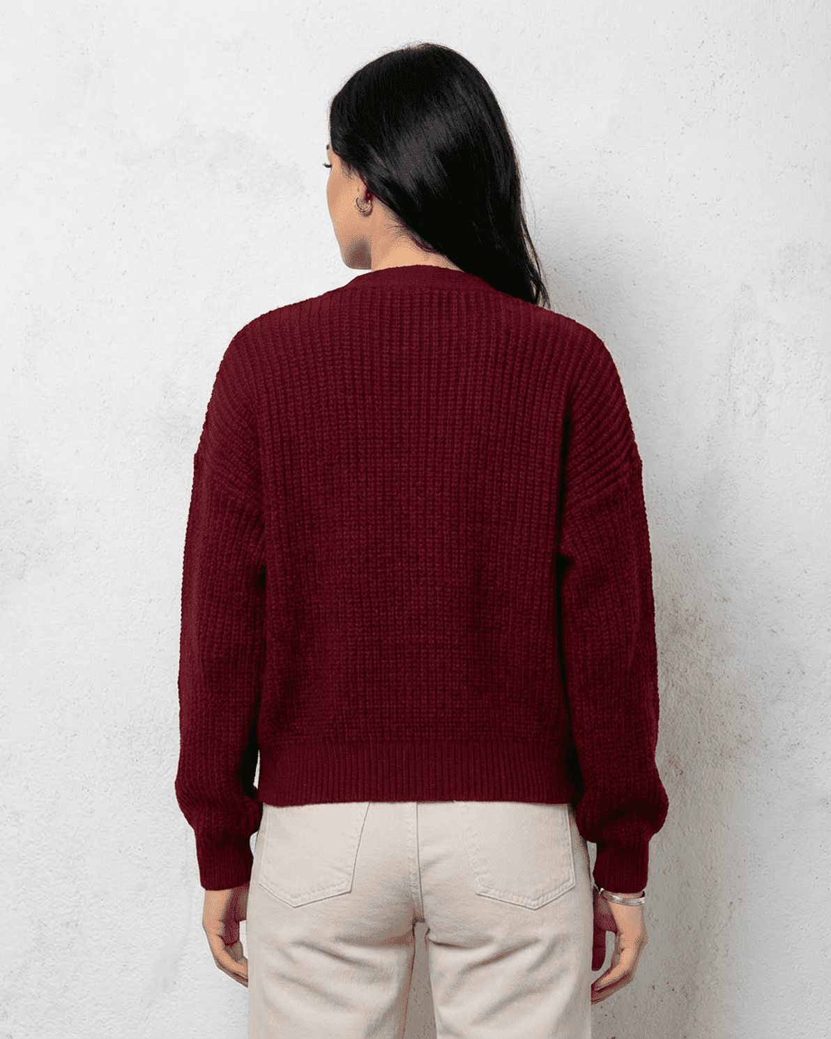 Back view of a woman wearing a luxurious burgundy Vesper Cardigan by Slimona, showcasing its elegant design.