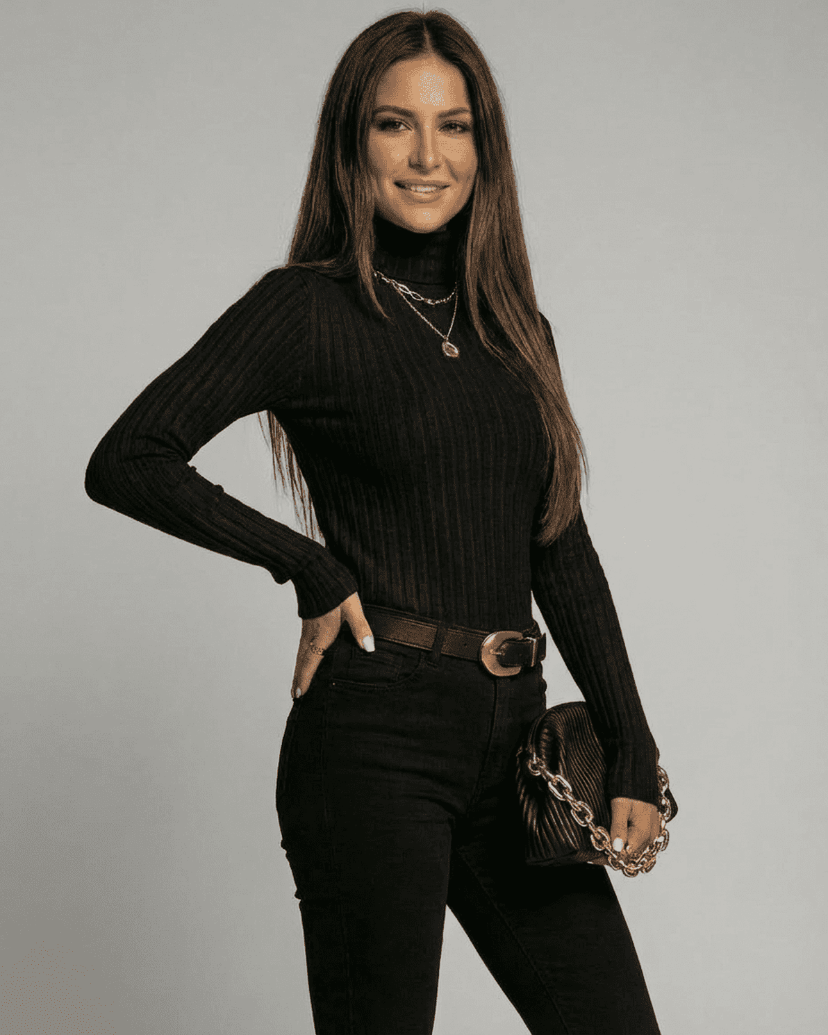 Vesper Sweater by Slimona worn by a model, showcasing a slim fit ribbed turtleneck in black.
