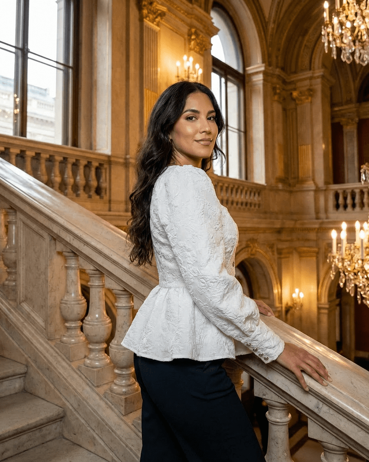 Ivory Corset Top modeled by a woman in an elegant setting, featuring jacquard fabric with puff sleeves and a square neckline.