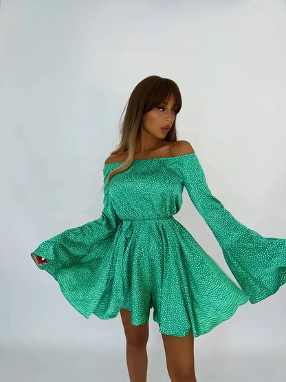 Model wearing the Luna Dot Mini Dress with flared sleeves and a green polka dot print, perfect for summer occasions.