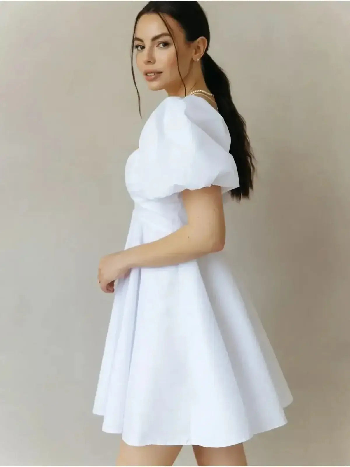 Luna Pearl Mini Dress in white, featuring flirty puff sleeves and a flared skirt, perfect for summer and wedding guest attire.