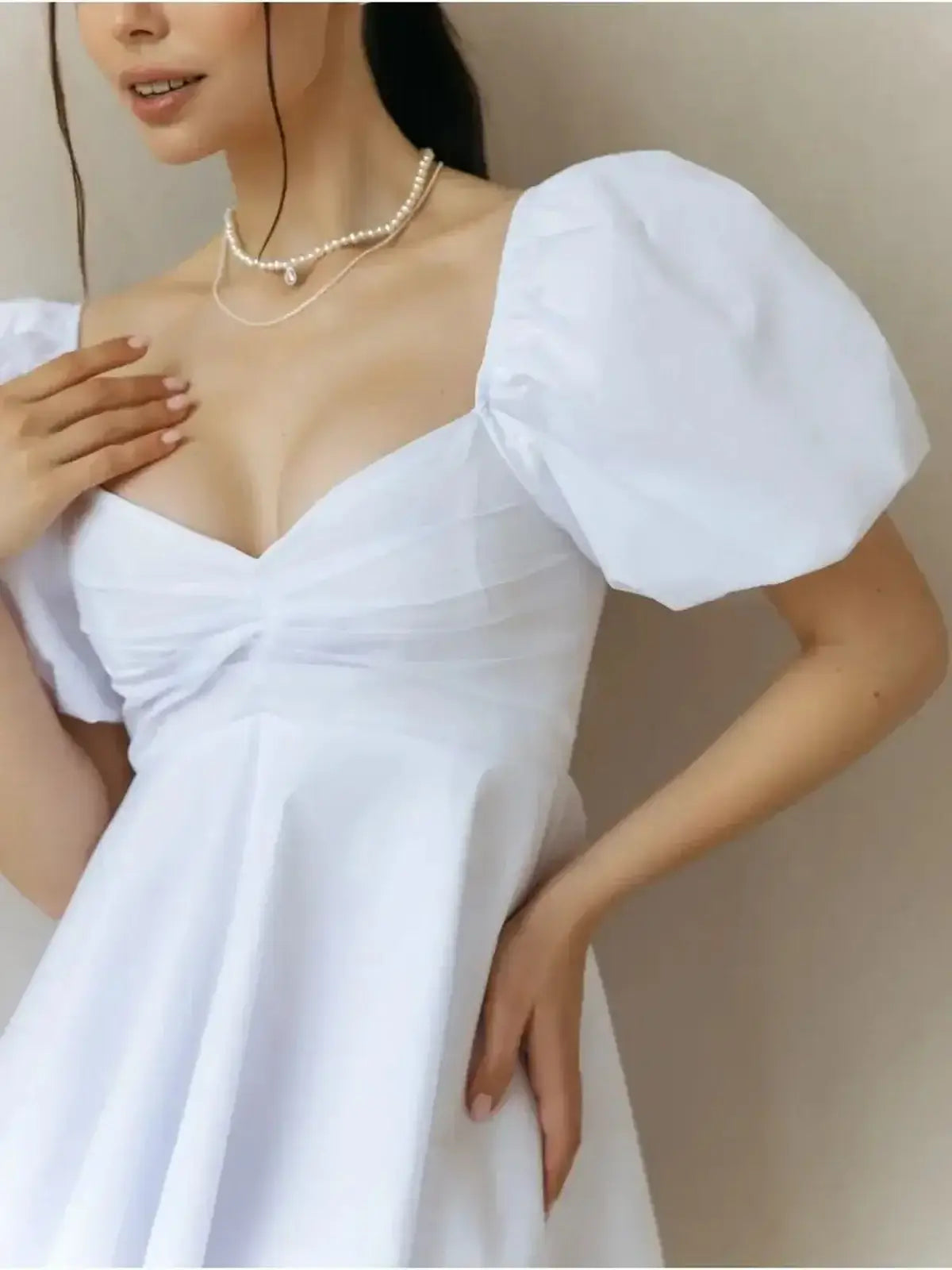 Luna Pearl Mini Dress with puff sleeves and sweetheart neckline in white, ideal for summer and special occasions.