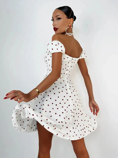 White mini dress with polka dots, off-shoulder design, and flared skirt, perfect for summer and dressy occasions.