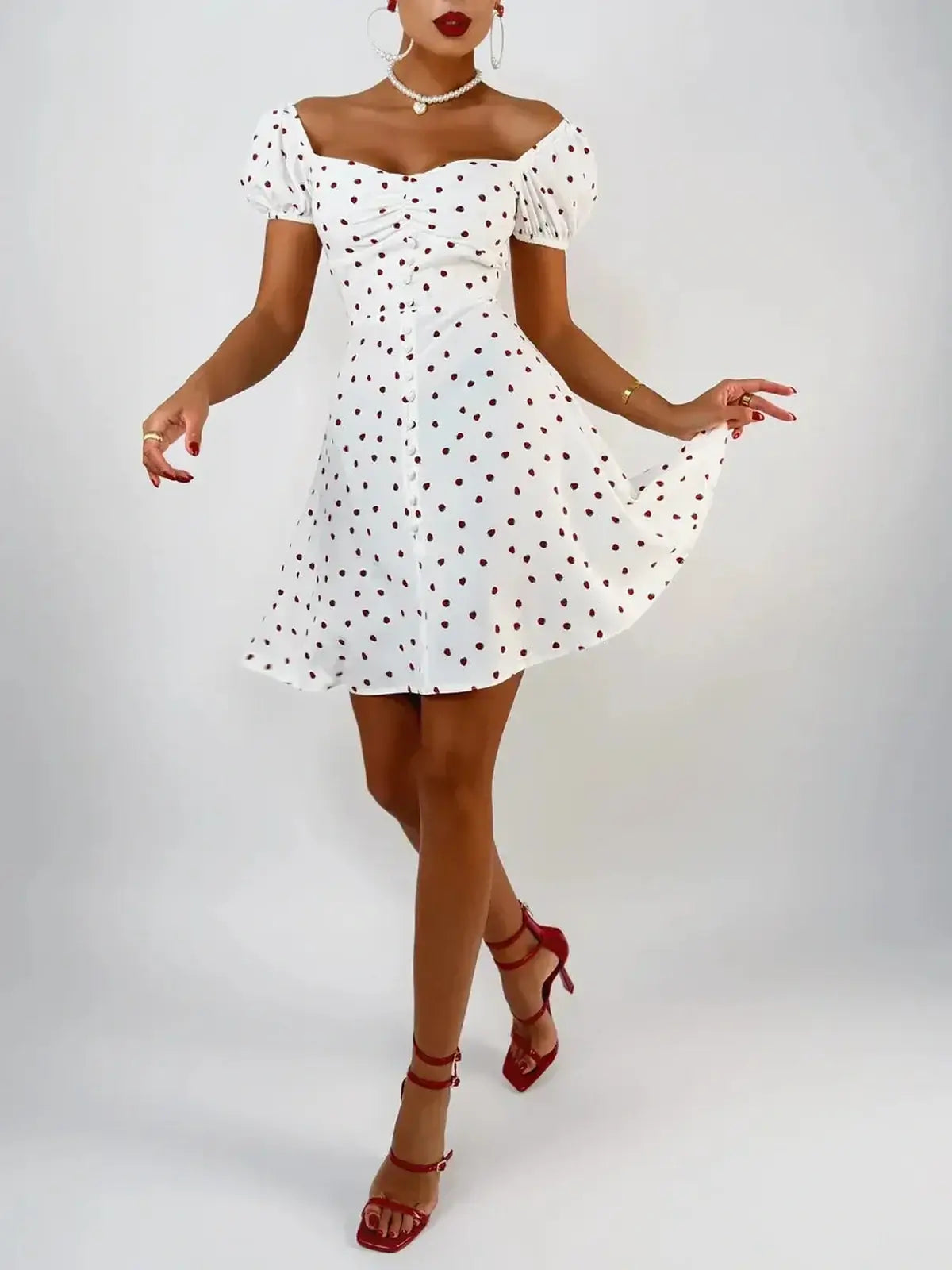 Model wearing a white mini dress with polka dots, perfect for summer, parties, and wedding guest attire.