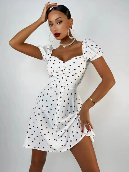 Model wearing a white mini dress with puff sleeves and polka dots, perfect for summer parties and casual outings.