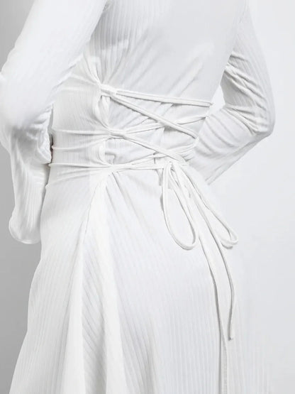 Back view of a white Luxe Lace-Up mini dress showcasing adjustable lace-up detail and flared sleeves.
