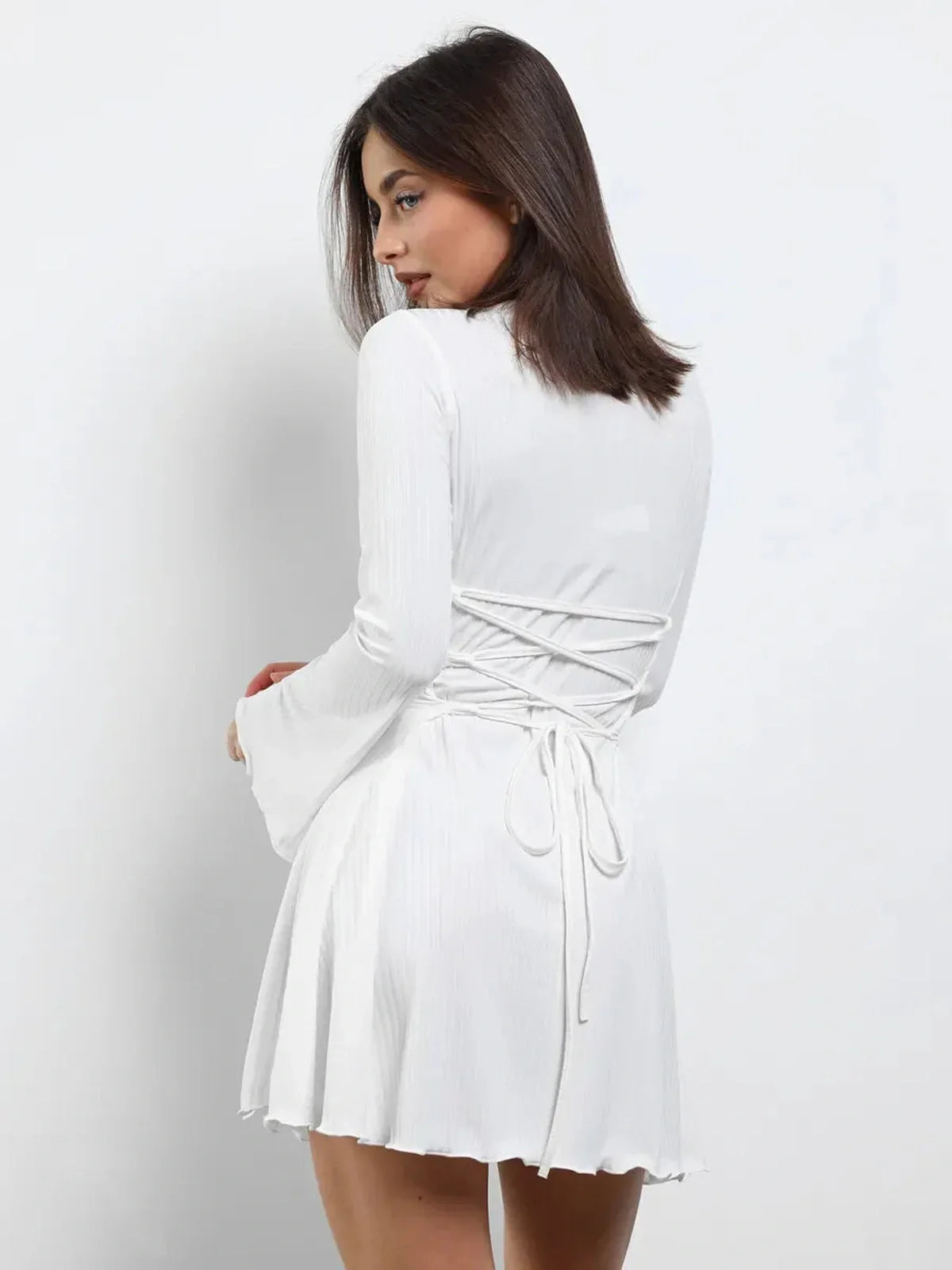 White Luxe Lace-Up mini dress with flared sleeves and adjustable back, perfect for wedding guests and summer events.