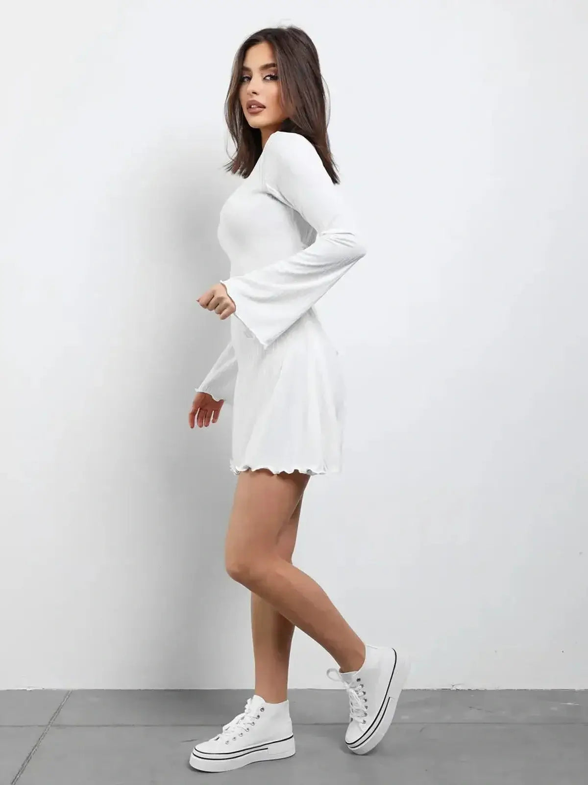 White Luxe Lace-Up mini dress with long sleeves and flared skirt, perfect for summer or wedding guest outfits.