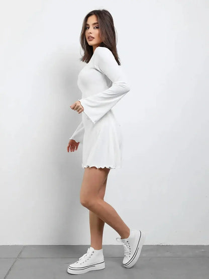 White Luxe Lace-Up mini dress with long sleeves and flared skirt, perfect for summer or wedding guest outfits.