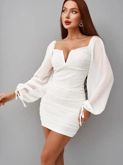 Luxe Spark white mini dress with off-the-shoulder neckline, ruched bodice, and bell sleeves, perfect for summer and weddings.