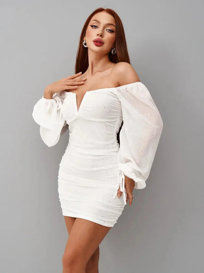 Model wearing a white mini dress with off-the-shoulder sleeves and a deep V-cut, perfect for summer parties and weddings.