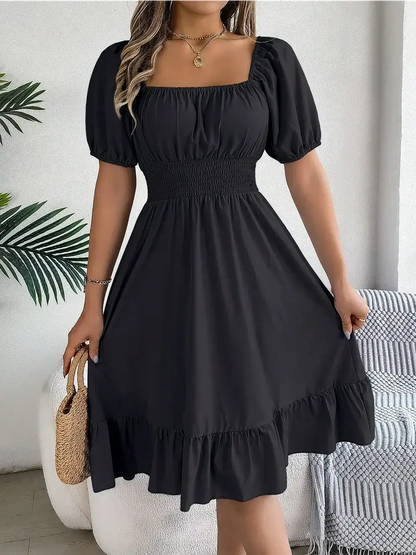 Black mini dress with structured square neckline and puff sleeves, perfect for summer and wedding guest occasions.