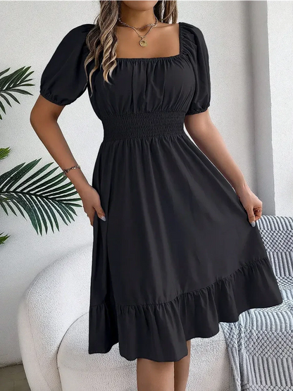 Black mini dress with structured square neckline and puff sleeves, ideal for summer occasions and weddings.