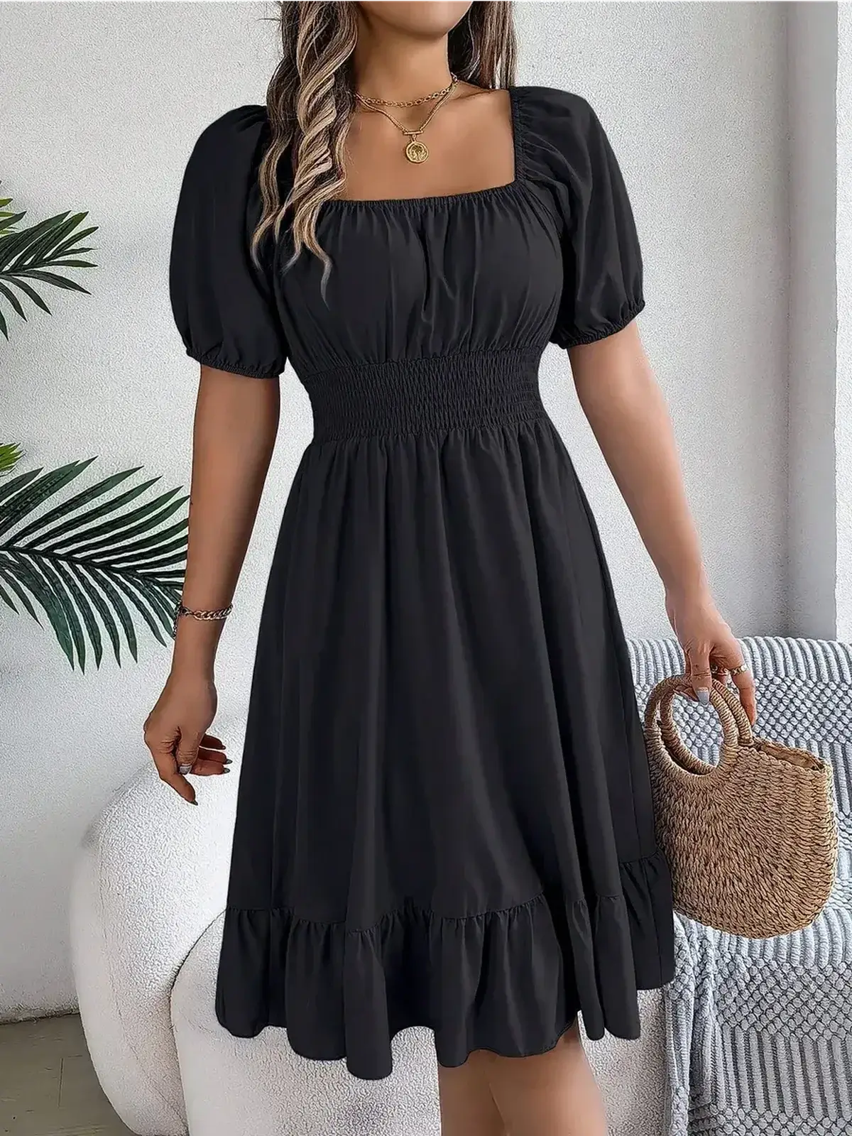 Black mini dress with puff sleeves and ruffled hem, perfect for summer parties and casual occasions.