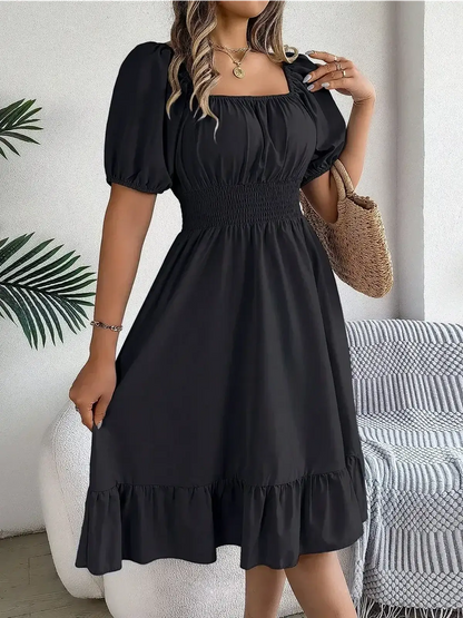 Black mini dress with puff sleeves and ruffled hem, perfect for summer and special occasions like weddings or parties.