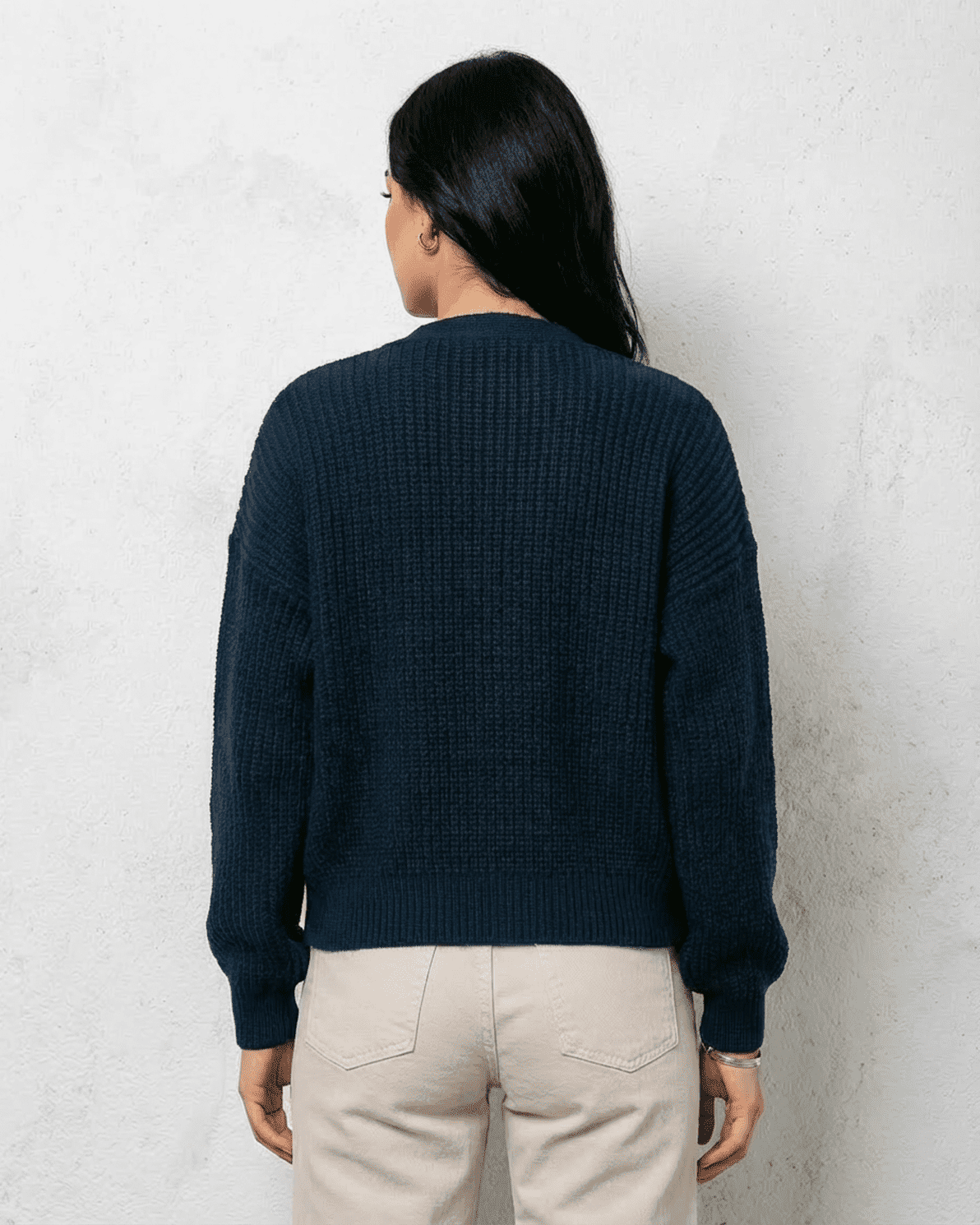 Back view of woman wearing the Midnight Cardigan by Slimona in deep navy knitwear.