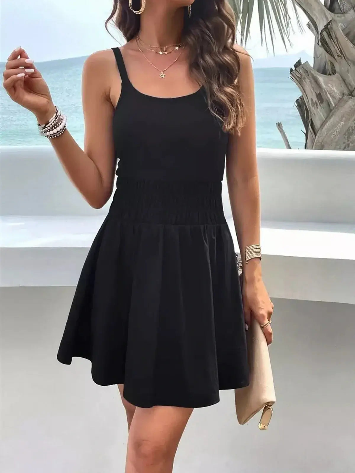 Model wearing the Midnight Coast Mini Dress, a black casual dress with a tank-style bodice and flared skirt.