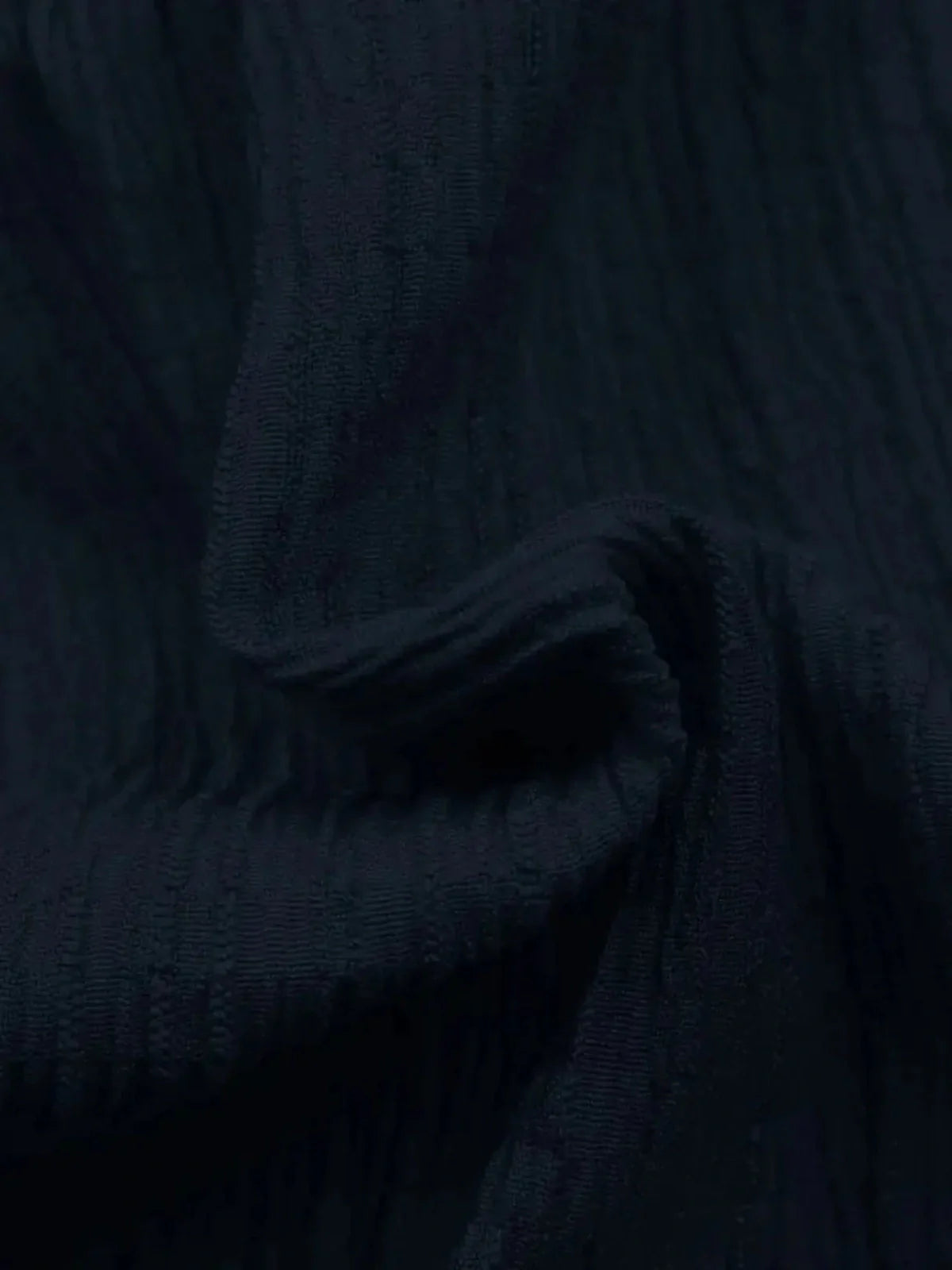 Close-up of soft, textured navy fabric ideal for making summer dresses and elegant cocktail dresses.