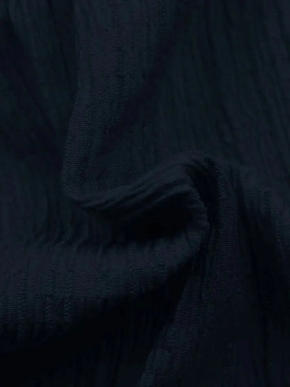 Close-up of soft, textured navy fabric ideal for making summer dresses and elegant cocktail dresses.