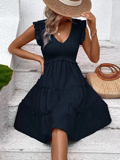 Black frill mini dress with deep V-neckline and ruffle sleeves, perfect for summer events and weddings.