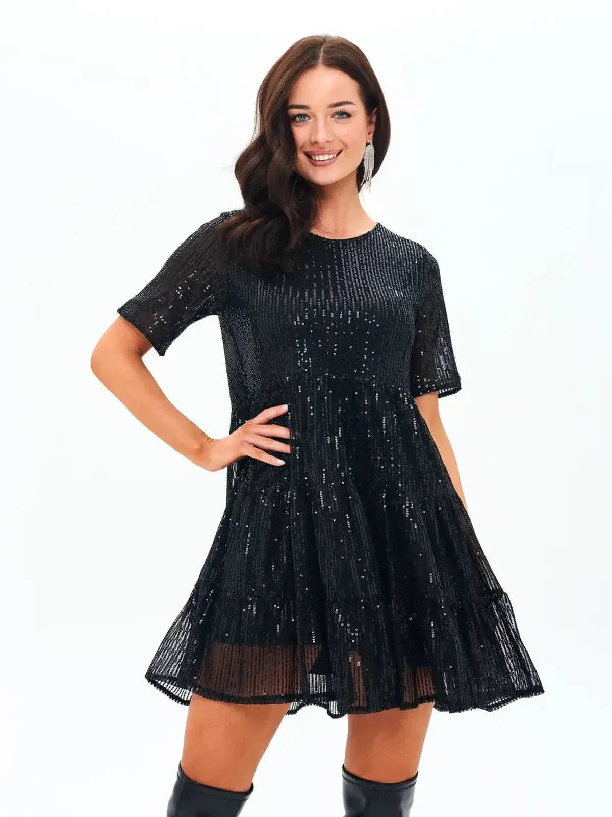 A model showcasing a sparkling black mini dress with sequins, perfect for parties and special occasions.