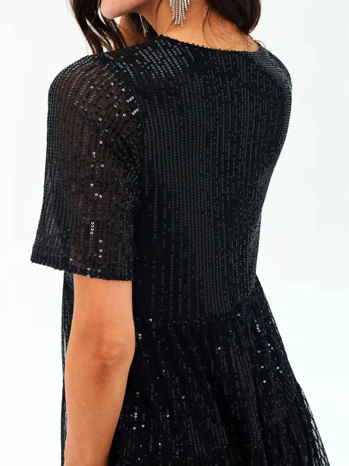 Back view of a sparkling black mini dress with sequins and short sleeves, perfect for evening wear.