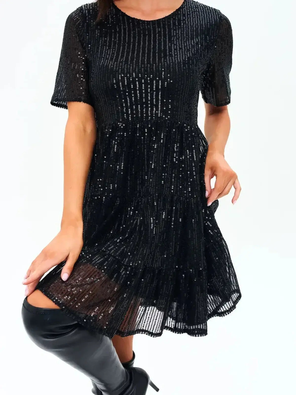 Sparkly black mini dress with short sleeves and ruffle-tiered hem, perfect for cocktail parties or special occasions.