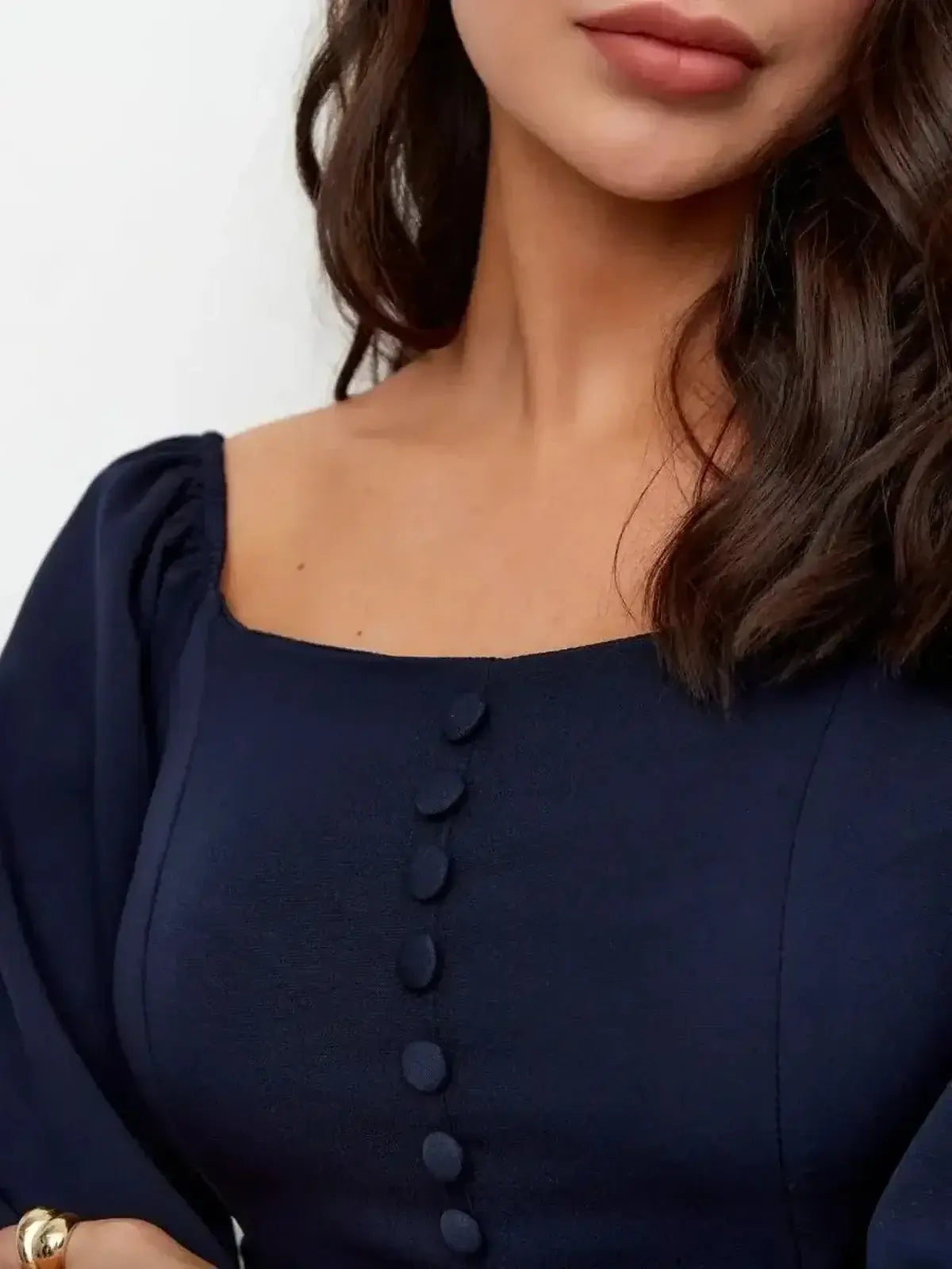 Close-up of Midnight Grace Mini Dress showing square neckline, sculptural sleeves, and tonal button detailing.