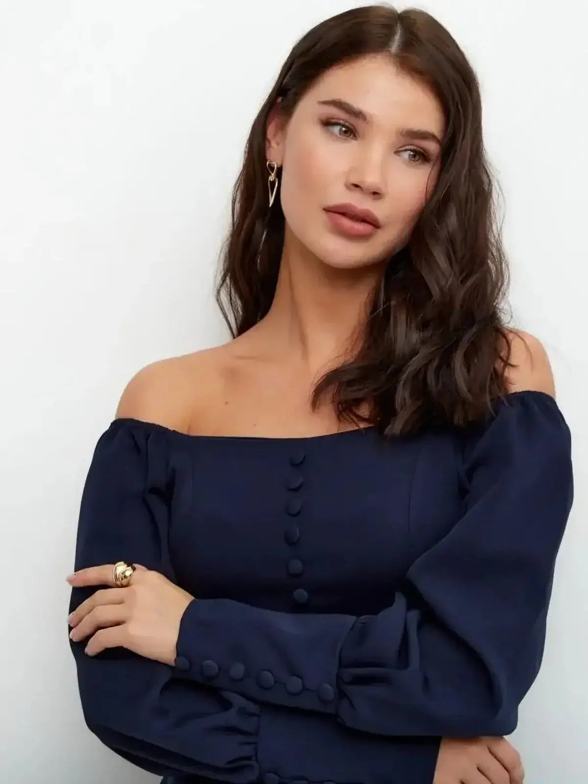 Model wearing the Midnight Grace Mini Dress in navy, featuring a square neckline and long sculptural sleeves with buttons.