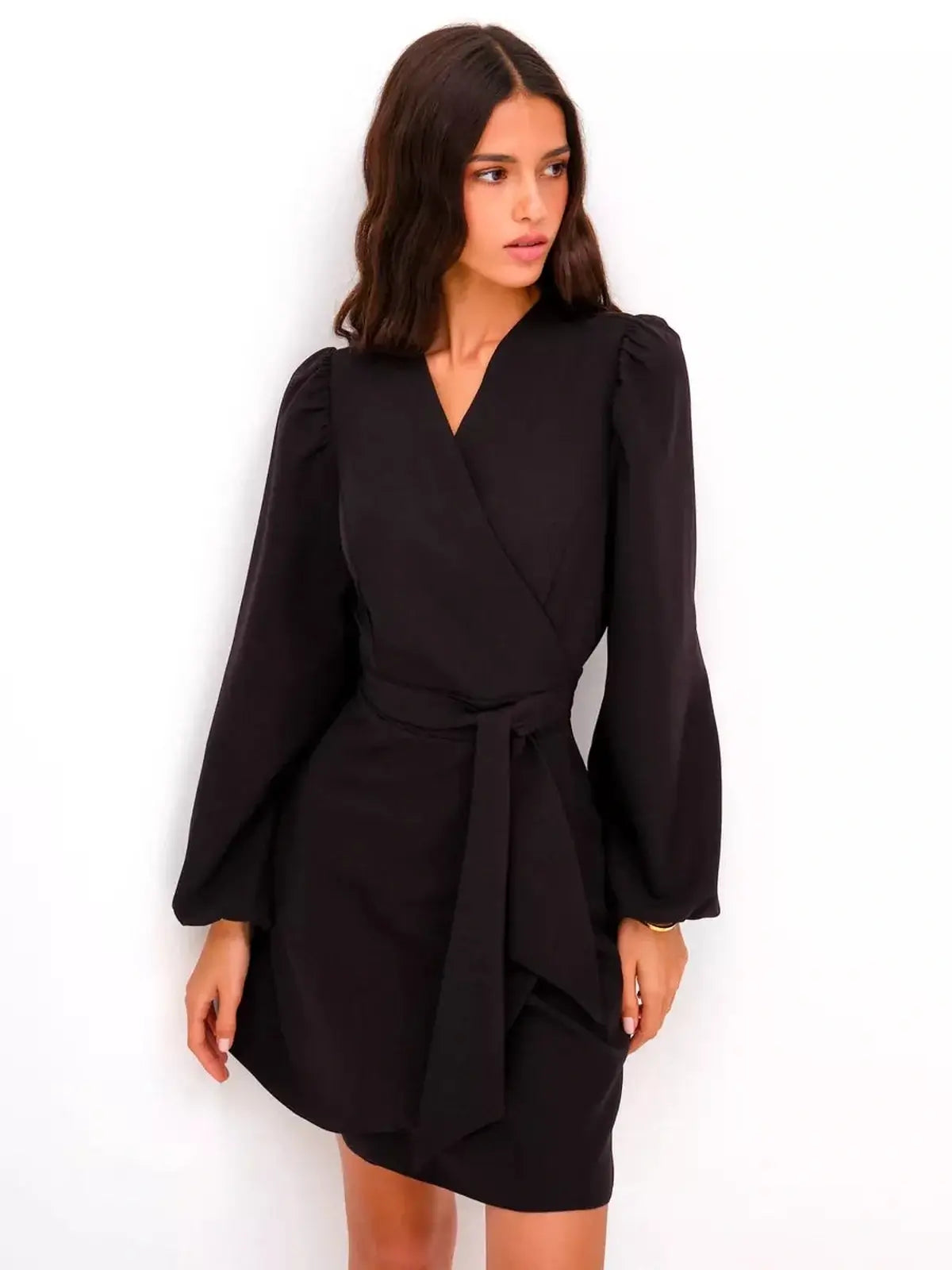 Model wearing a black midi dress with a wrap silhouette and bell sleeves, perfect for formal and cocktail occasions.
