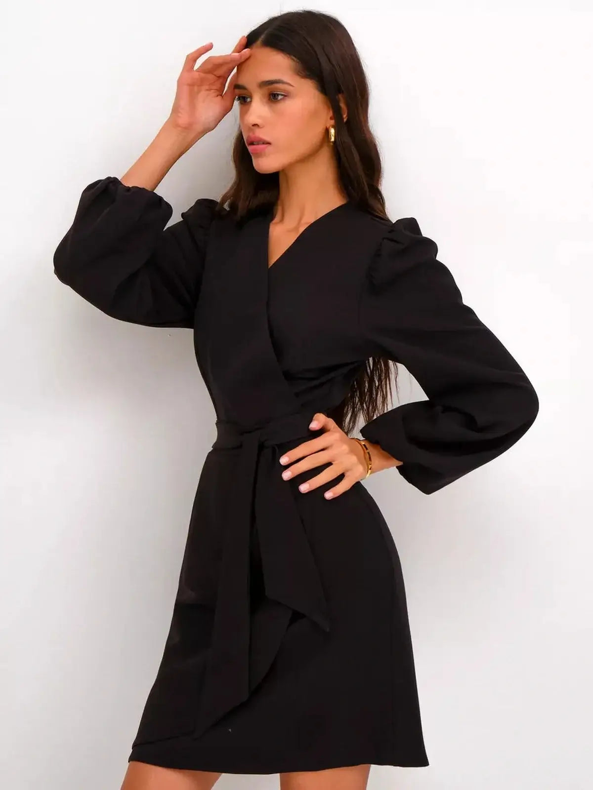 Elegant black midi dress with a wrap silhouette and V-neckline, perfect for wedding guests or formal occasions.