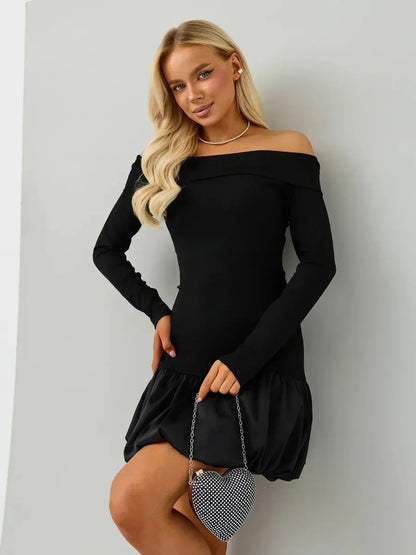 A woman wearing the Midnight Petal black mini dress with off-the-shoulder neckline and balloon skirt.