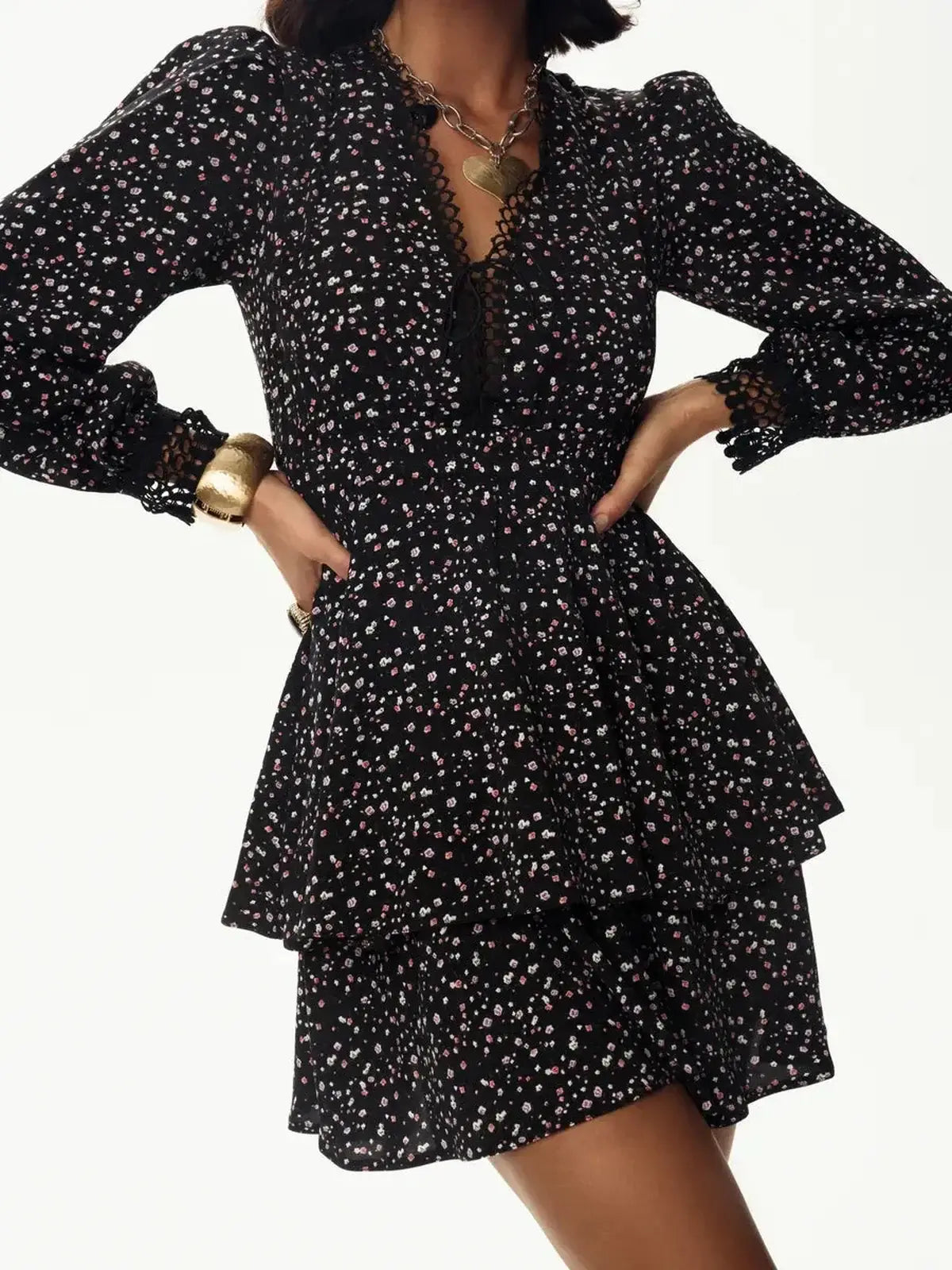 Black mini dress with floral pattern, deep V-neckline, and long sleeves, perfect for summer parties or evening events.