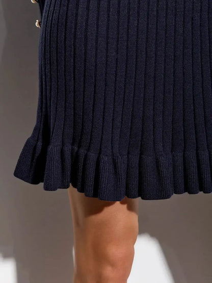 Close-up of a navy mini dress featuring ribbed texture and flared hem for a stylish look.