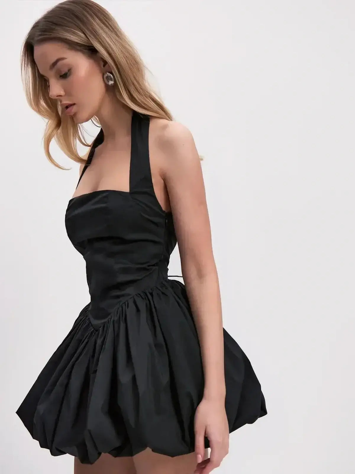Bold black mini dress with square neckline and gathered bubble skirt, perfect for summer parties or evening events.