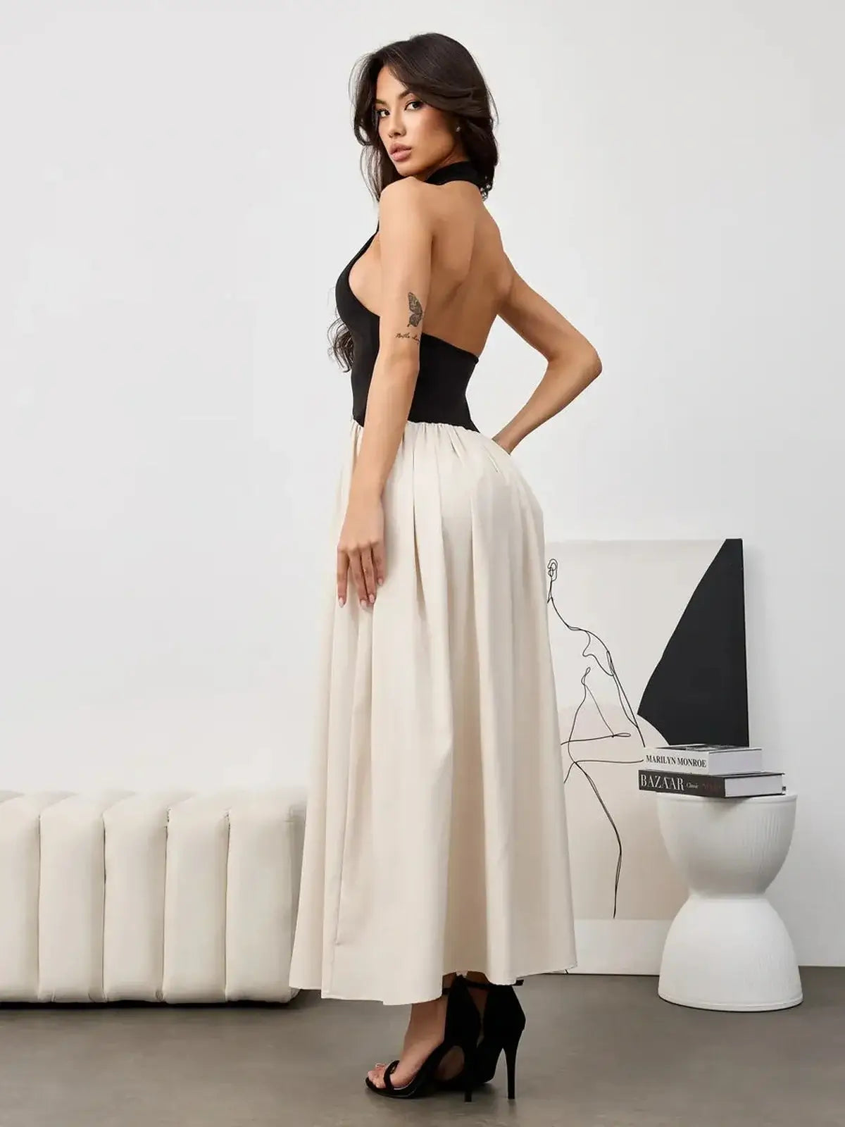 Muse Hourglass black and beige midi dress features a halter-style bodice and flowy skirt, perfect for formal and summer occasions.